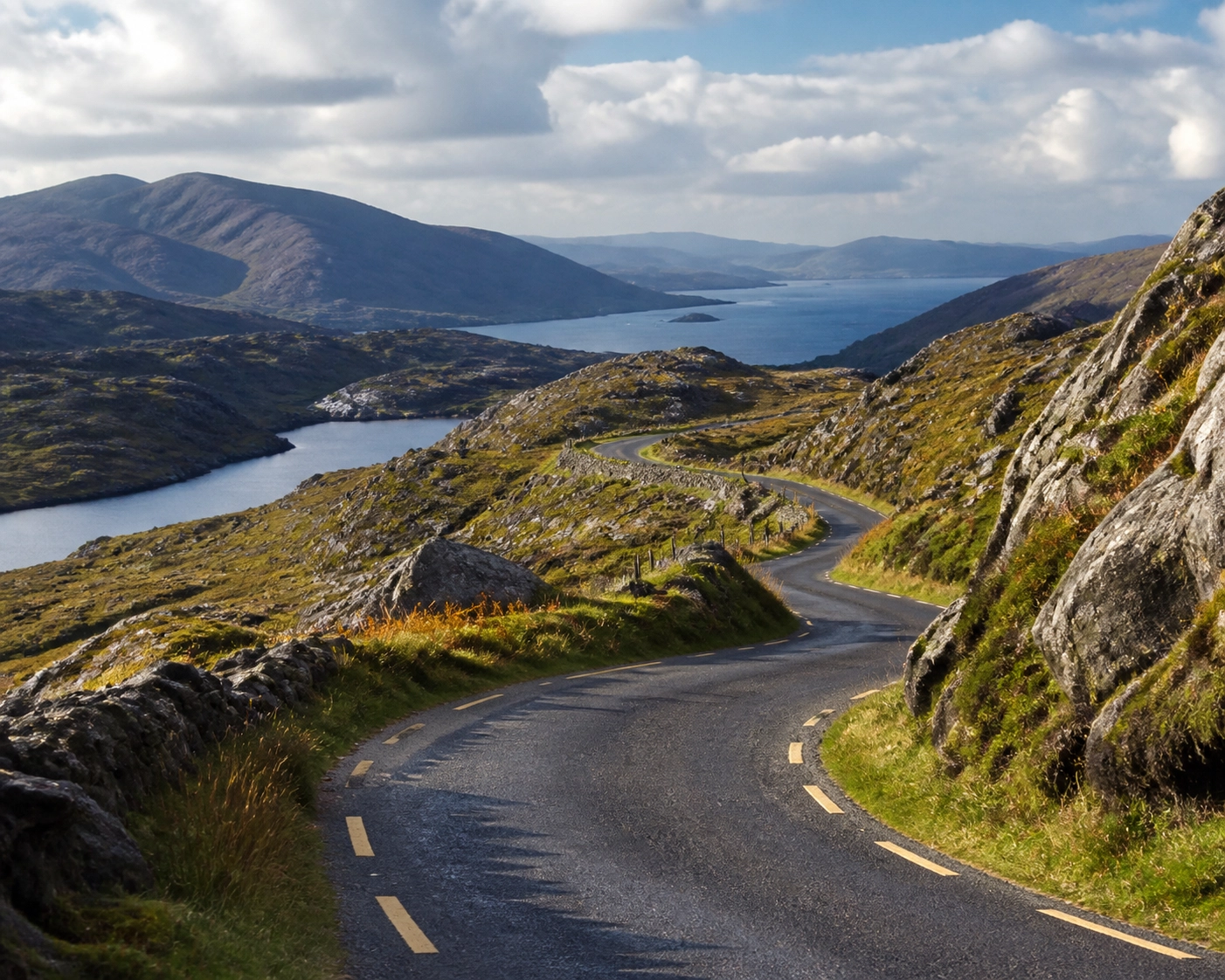 A breathtaking scenic mountain road winding through the rugged landscape of the Ring of Beara near Kenmare under soft natural light